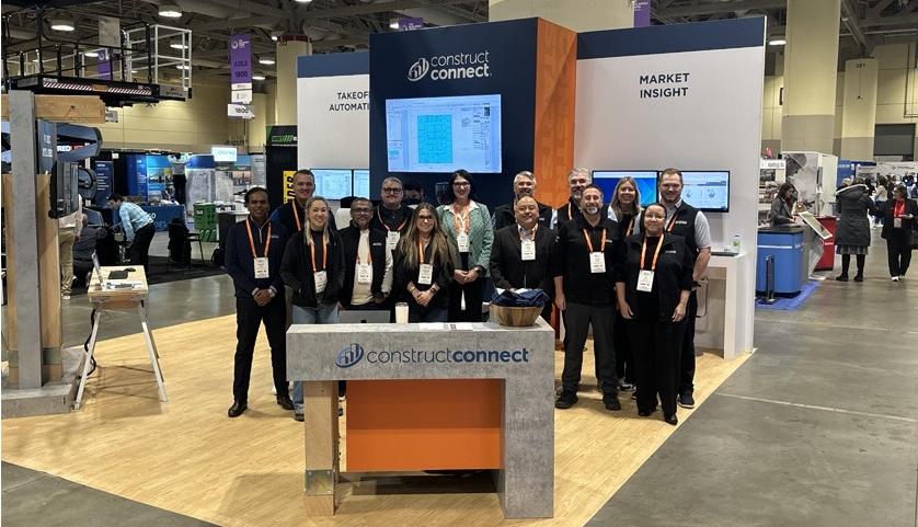 The ConstructConnect team on the floor at The Buildings Show standing in their booth.