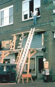 Example of dangerous scaffolding in construction, showing prohibited lean to scaffold supported by a dumpster (IMAGE - OSHA)