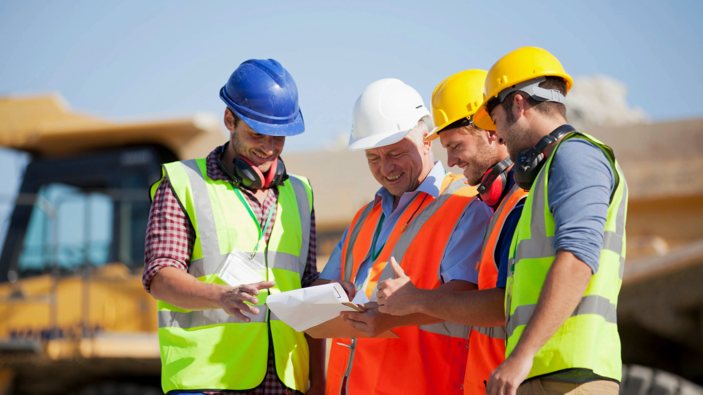 Construction workers on a job site looking at project plans