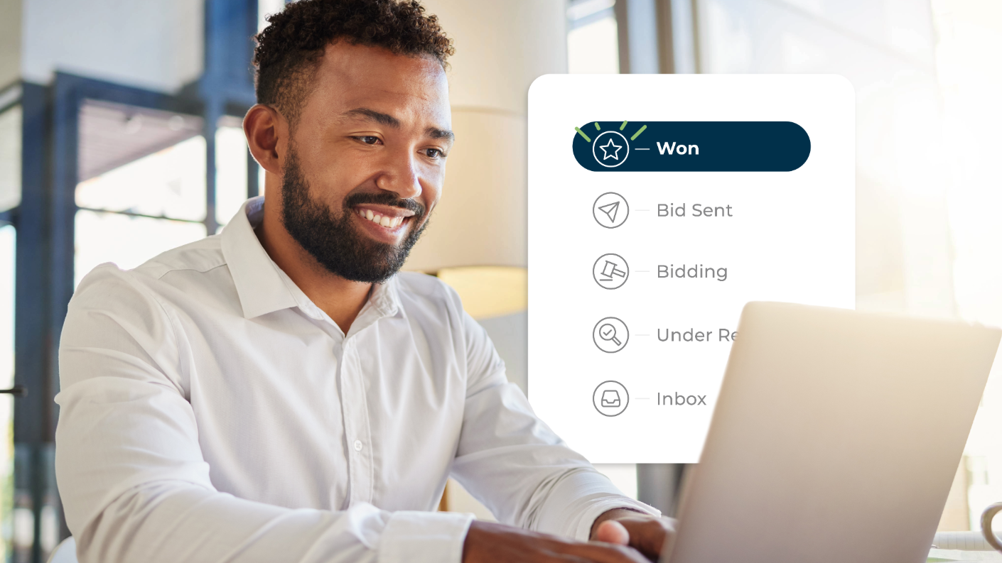 man smiling while typing on a computer