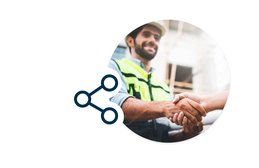 Two construction workers who connected through ConstructConnect’s network are meeting and shaking hands.